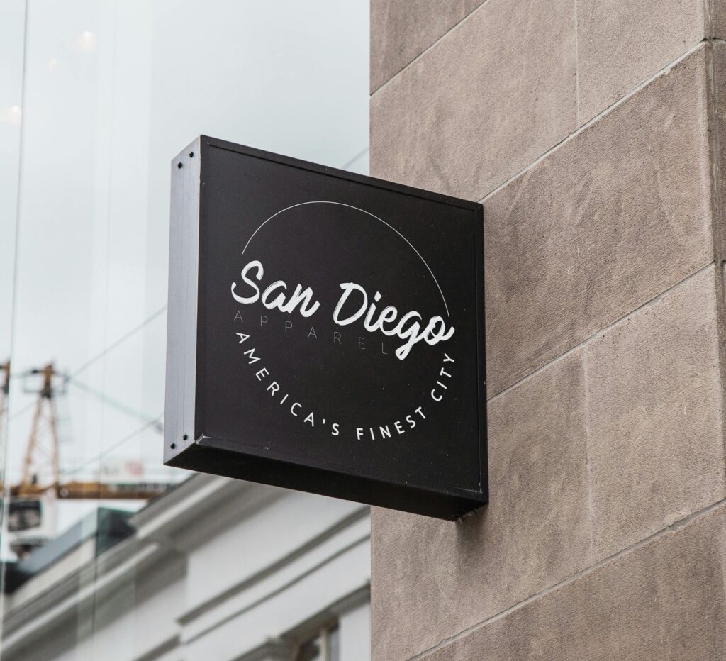 Storefront signage for a San Diego apparel shop displaying city pride.